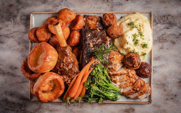 Sharing platter of steak, chicken and sides for a birthday group at Decorum Birmingham