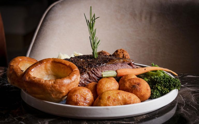 Halal dry-aged steak plated with rosemary and seasonal sides at Decorum Birmingham