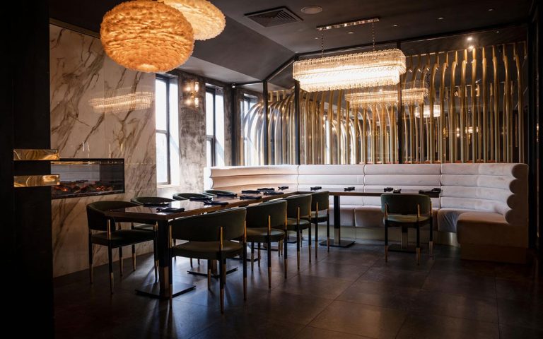 Moody candlelit dining room set for two at Decorum Birmingham romantic restaurant